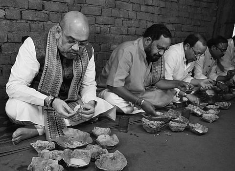 Amit Shah and other BJP leaders having lunch at the house of a Dalit in Deogaon village in Balangir | irfana