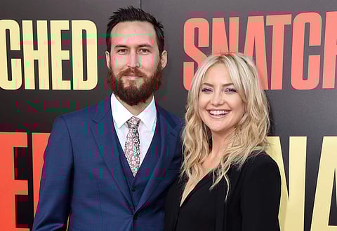 FILe - In this May 10, 2017 file photo, Danny Fujikawa, left, and Kate Hudson arrive at the Los Angeles premiere of 'Snatched.' | AP