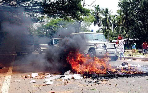 Anti-survey protesters burn tyres on NH 66 following clashes with the police at Kooriyad in Malappuram on Friday | Express