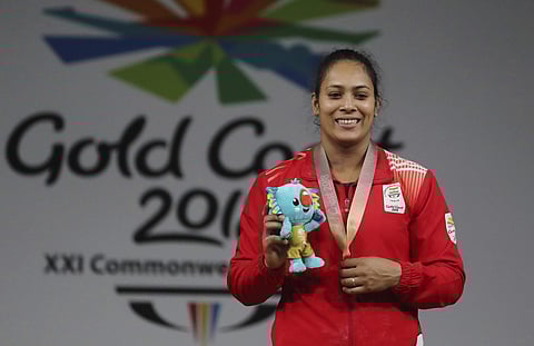 India's Women's 69Kg Weightlifting Gold medalist Punam Yadav poses for the photographer during medal ceremony at the Commonwealth Games in Gold Coast, Australia, Sunday, April 8, 2018. (AP Photo/Manish Swarup)