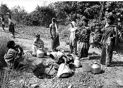 Women collect water from a ‘chua’ in the village | Express