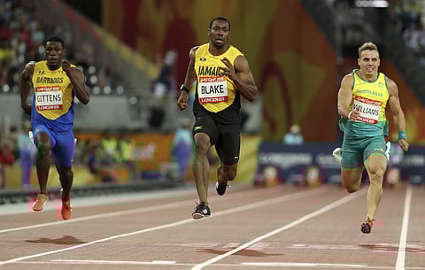 Jamaica's Yohan Blake, centre, runs in his men's 100m semifinal at the Carrara Stadium during the 2018 Commonwealth Games on the Gold Coast, Australia, Sunday, April 8, 2018. | AP