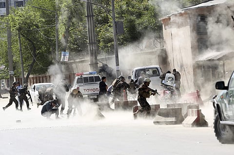 Security forces run from the site of a suicide attack after the second bombing in Kabul, Afghanistan, Monday, April 30, 2018. (AP)