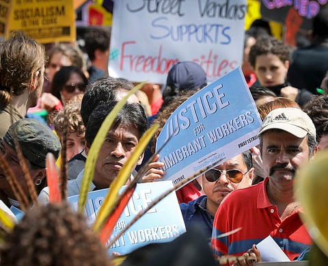 People participate in a May Day rally in New York. (AP Photo)