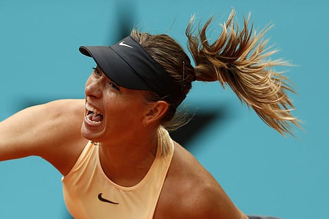 Maria Sharapova from Russia serves to Kristina Mladenovic from France during a Madrid Open tennis tournament. | AP