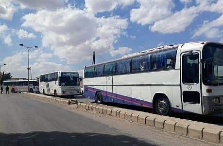 Image of a convoy of buses carrying rebels and their family leave the region in the Damascus countryside, Syria.