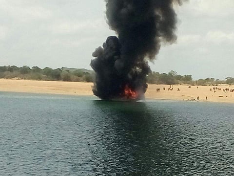 Smoke engulfs a boat which caught fire in Godavari river. (Ravuri)