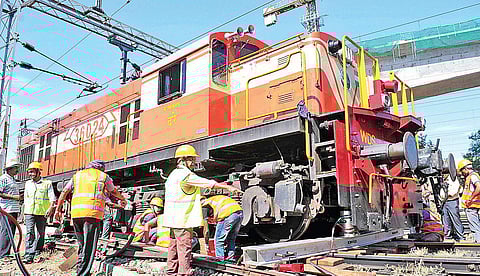 Railway engineers trying to lift the train engine which got derailed at South Railway station on Thursday | A Sanesh