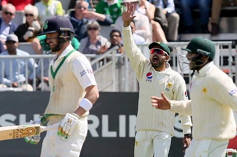Pakistan's Babar Azam (C) appeals for the wicket of Ireland's Andrew Balbirnie (L) during play on day three of Ireland's inaugural Test match against Pakistan at Malahide cricket club, in Dublin on May 13, 2018. | AFP