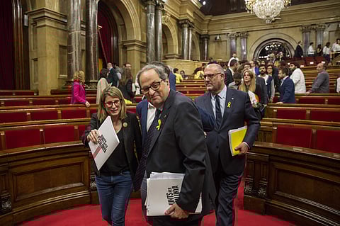 Separatist lawmaker Quim Torra, candidate for regional president, leaves the chamber at the end of the parliamentary session in Barcelona, Spain, Saturday, May 12, 2018.