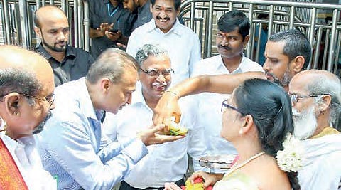 ADAG Chairman Anil Ambani accepts prasadam from a priest after having darshan at Durga temple in Vijayawada on Monday | Express