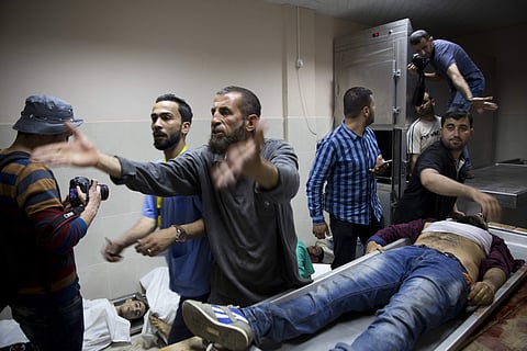 Bodies of Palestinians killed during a protest on a border with Israel lay in the morgue in Beit Lahiya, Gaza Strip, Monday, May 14, 2018. Israeli soldiers shot and killed dozens of Palestinians during mass protests along the Gaza border on Monday (AP Pho