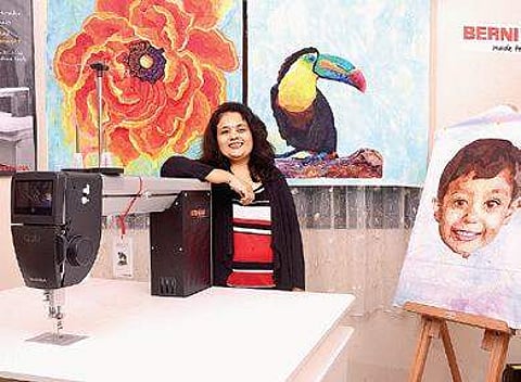 Kalindi Hambir, displaying the quilt art she has worked on