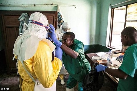 ealth workers don protective gear before examining suspected Ebola patients at Bikoro hospital in DR Congo's Equateur province. | AFP