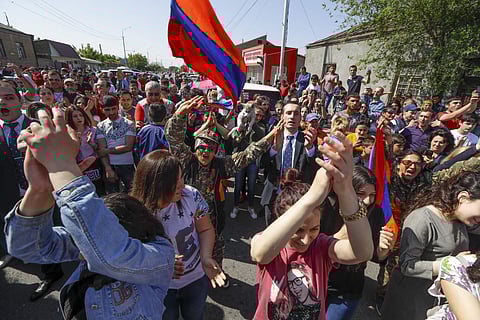 Supporters of the opposition lawmaker Nikol Pashinian dance and sing as they block a road to the airport just outside Yerevan. (Photo | AP)