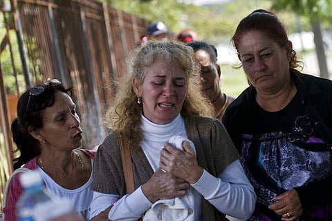 Grieving relatives of passengers who perished in Cuba's worst aviation disaster leave the morgue, in Havana, Cuba. | AP