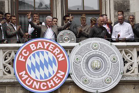 Bayern coach Jupp Heynckes celebrates on the balcony of the town hall at Marienplatz square the 28th Bundesliga title at the German first division Bundesliga in Munich, Germany, Sunday, May 20, 2018. | AP