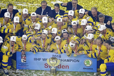 Sweden team pose with the trophy after their victory over Switzerland in the Ice Hockey World Championships final match at the Royal arena in Copenhagen, Denmark. | AP