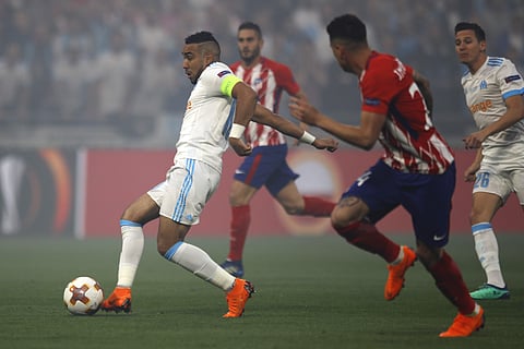 Marseille's Dimitri Payet, left, and Atletico's JosĂ© MarĂa Gimenez, second right, vie for the ball during the Europa League Final soccer match between Marseille and Atletico Madrid at the Stade de Lyon in Decines, outside Lyon, France, Wednesday, May 16,
