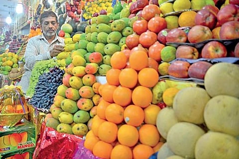 A vendor arranges fruits at his stall. Image used for representational purpose only. (Photo| Pushkar V)