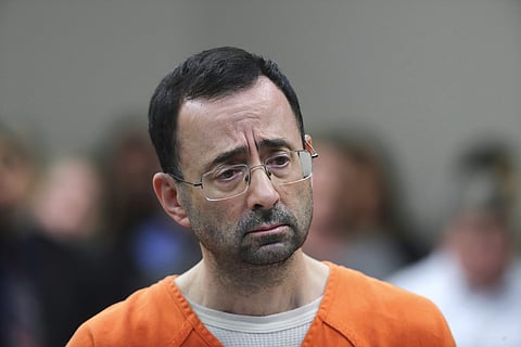FILE - In this Nov. 22, 2017, file photo, Dr. Larry Nassar appears in court for a plea hearing in Lansing, Mich. Michigan State University has reached a $500 million settlement with hundreds of women and girls who say they were sexually assaulted by Nassa