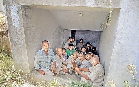 In Jammu’s Arnia village, villagers take shelter in a community bunker during Pakistani shelling on Tuesday. | PTI