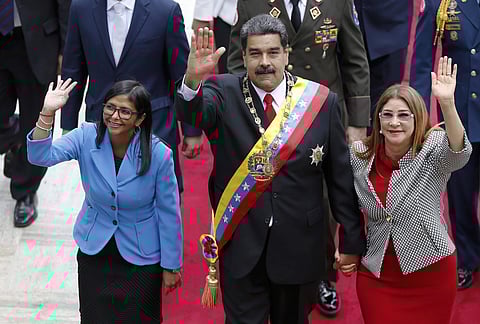 Venezuela's President Nicolas Maduro, center, Constituent National Assembly President Delcy Rodriguez, left, and first lady Cilia Flores, wave as they arrive to the National Assembly for a special session in Caracas, Venezuela, Thursday, May 24, 2018. | A