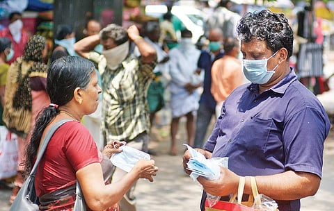A man selling surgical mask to the people coming to the Government Medical College Hospital in Kozhikode. (Photo | Manu R Mavelil)