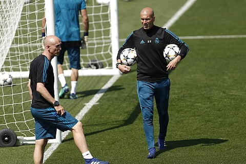 Real Madrid head coach Zinedine Zidane walks along the pitch during a training session during the open media day at the team's Veldebebas training ground in Madrid. | AP