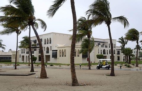 A club car passes the trees at a hotel in Salalah, Oman, Friday, May 25, 2018. Cyclone Mekunu will be 'extremely severe' when it crashes into the Arabian Peninsula this weekend, meteorologists warned Friday, after earlier thrashing the Yemeni island of So
