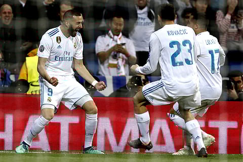 Real Madrid's Karim Benzema, left, celebrates with team mates Mateo Kovacic and Lucas Vazquez after scoring twice for his side against FC Bayern Munich. (AP)