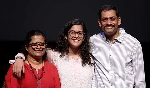Meghna, a student of Step By Step school, with her parents. (EPS)