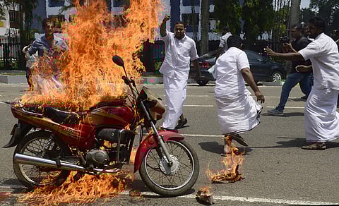 A bike set on fire by Youth Congress activists against the price hike of petrol and diesel infront of IOC office,Panampilly Nagar in Kochi on Saturday. (Express Photo)