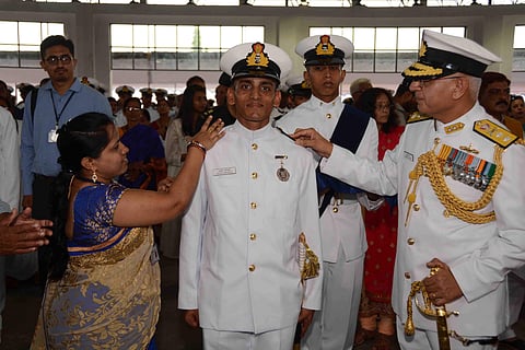 Vice admiral R B Pandit Commandant of INA and mother of midshipman Ashish Panigrahi shipping the Naval epaulettes, known as Stripes on his shoulders, after the passing out parade at the Indian Naval Academy at Ezhimala in Kannur district on Saturday. (EPS