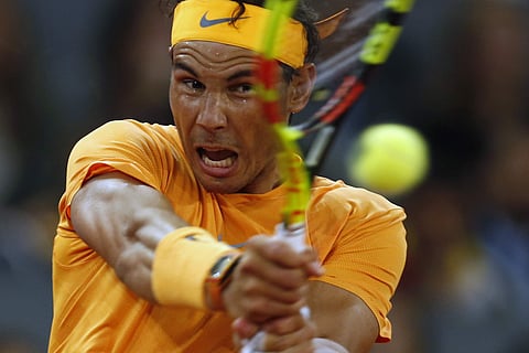 FILE - In this May 10, 2018, file photo, Rafael Nadal makes a return against Diego Schwartzman, of Argentina, at the Madrid Open tennis tournament in Madrid, Spain. Nadal will be competing in the French Open tennis tournament that begins on Sunday, May 27