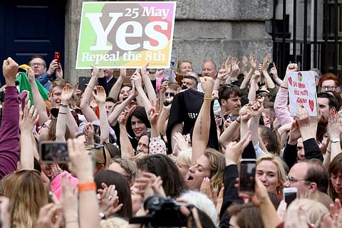 'Yes' campaigners celebrate the official result of the Irish abortion referendum at Dublin Castle in Dublin on May 26, 2018 which showed a landslide decision in favour of repealing the constitutional ban on abortions. | AFP
