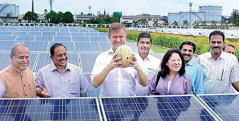 United Nations Environment Programme executive director Erick Solheim with a pumpkin cultivated on the ground beneath the solar power plant at the Cochin International Airport, on Saturday | A Sanesh