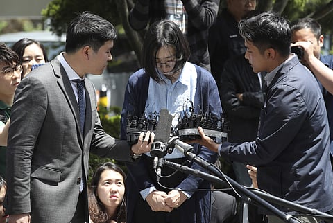Cho Hyun-ah, center, is questioned by reporters before entering a Korea Immigration Service office for questioning in Seoul, South Korea, Thursday, May 24, 2018. | Associated Press