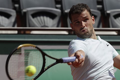 Bulgaria's Grigor Dimitrov returns the ball to Egypt's Mohamed Safwat during their first round match of the French Open | AP