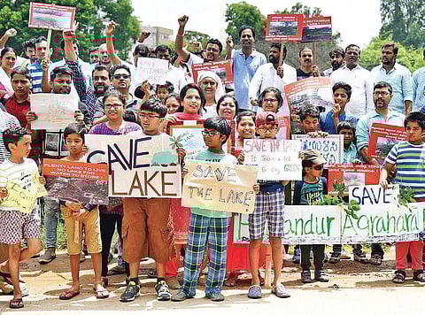 Whitefield residents, including children, during their protest against encroachments at Pattandur Agrahara lake in Bengaluru on Sunday. They want the Chief Minister to form a panel to look into the issue | Nagaraja Gadekal