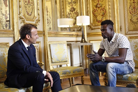 French President Emmanuel Macron, left, meets with Mamoudou Gassama, 22, from Mali, at the presidential Elysee Palace in Paris, Monday, May, 28, 2018. | AP