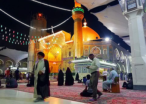 Shiite Muslim worshippers gather outside the holy shrine of Imam Ali, the son-in-law and cousin of the Prophet Muhammad and the first Imam of the Shiites, during the Muslim holy month of Ramadan in Najaf, 100 miles (160 kilometers) south of Baghdad, Iraq,