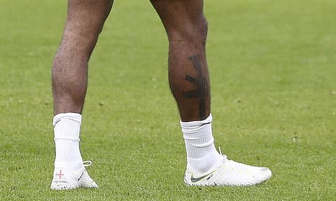 England's Raheem Sterling visibly showing a tattoo on his leg during a training session at St George's Park, England | AP