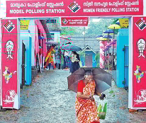 A woman comes out of a model polling station after casting vote | Express
