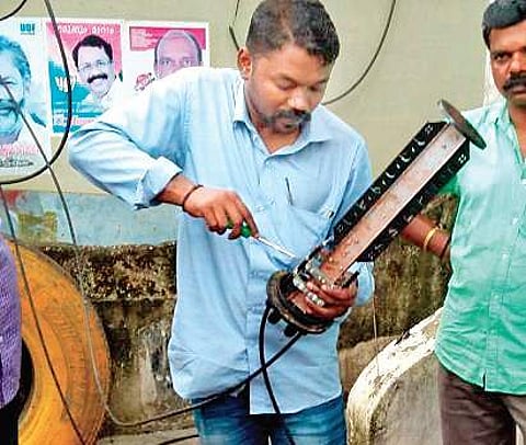 A cable operator trying to reconnect an optical fibre cable which was severed at Chengannur on Monday | Express