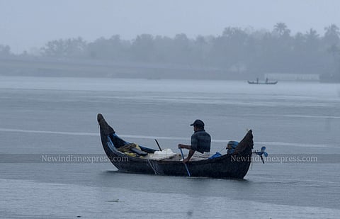 A man rowing his boat in Kochi, Kerala.