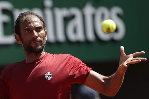 Egypt's Mohamed Safwat returns the ball to Bulgaria's Grigor Dimitrov during their first round match of the French Open tennis tournament at the Roland Garros Stadium, Sunday, May 27, 2018 in Paris. | AP