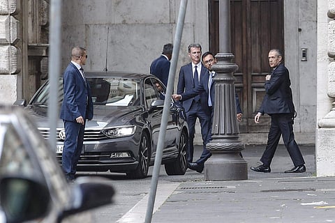 Designated Italian Prime Minister Carlo Cottarelli, right, leaves the Lower House in Rome | AP