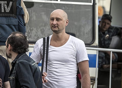 In this photo taken on Friday, May 31, 2013, Arkady Babchenko, 41, who had been scathingly critical of the Kremlin in recent years, stands at a police bus during an opposition rally in Moscow, Russia. | Associated Press