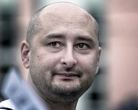In this photo taken on Friday, Aug. 9, 2013, Arkady Babchenko, 41, who had been scathingly critical of the Kremlin in recent years, looks at an opposition picket in Moscow, Russia. | AP